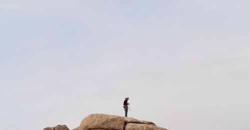 Person Standing On Cliff