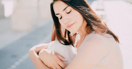 Woman in Wedding Dress Hugging her Knees