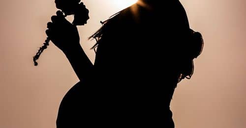 Silhouette of Woman Holding Microphone during Sunset