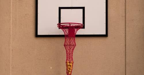 A basketball hoop with a red net hanging from it