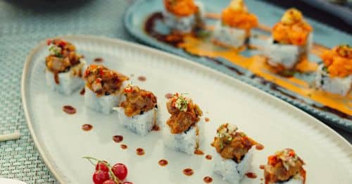 A table with sushi and other food on it