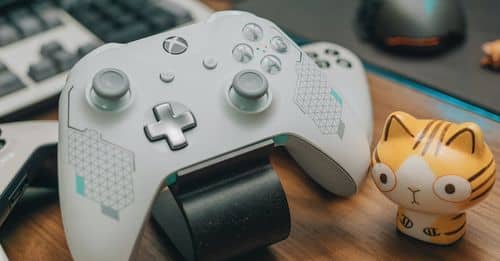 White Xbox Controller on Brown Wooden Surface