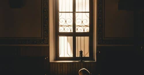 Photo Of Man Kneeling While Praying