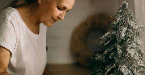 Selective Focus Photography of Standing Woman in Front of Dish