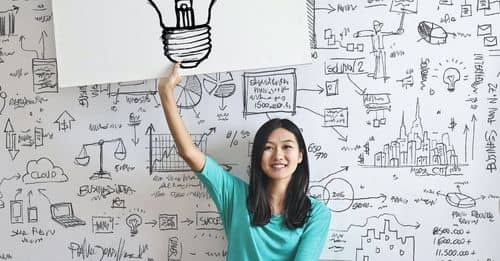 Woman Draw a Light bulb in White Board