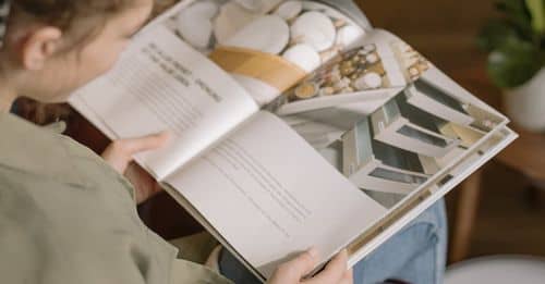 Girl in Gray Jacket Reading Book