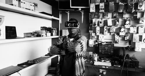 Black man in VR goggles in electronics store