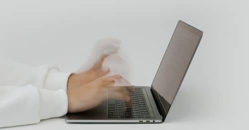 Hands Typing on a Laptop Keyboard