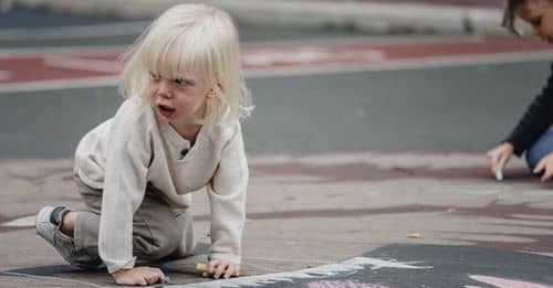 Emotional girl on ground looking away