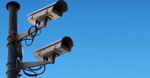 Surveillance cameras against blue sky