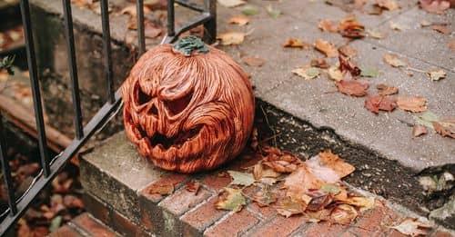 Carved pumpkin placed on stairs on Halloween