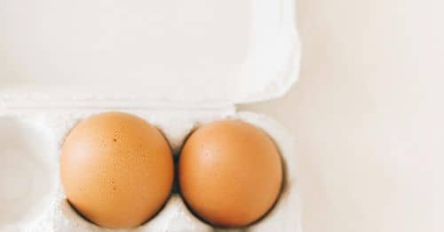 Three Brown Eggs In A Carton