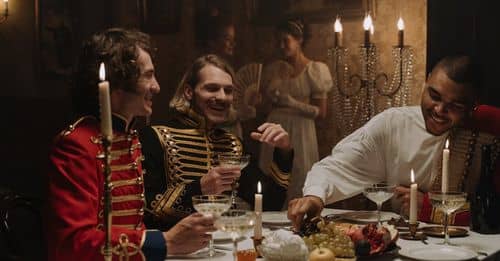 Men in British Military Costumes Sitting by the Table Having a Feast