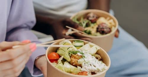 Two People Eating Healthy Food In Bowls