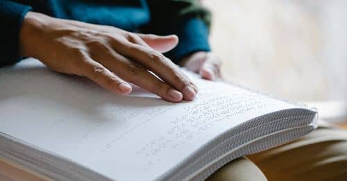 Close-Up Photo Of Person Using Braille 