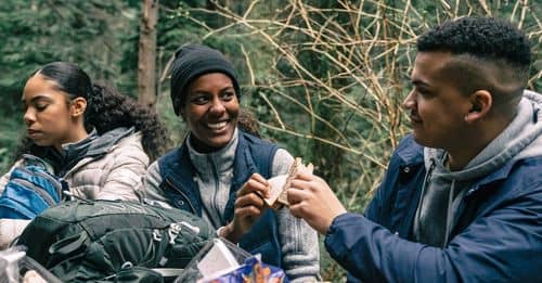 Man and Woman Having Fun while Eating Sandwiches