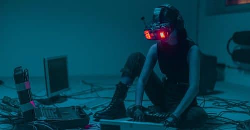 A Person Sitting on the Floor with Vr Goggles Using a Computer