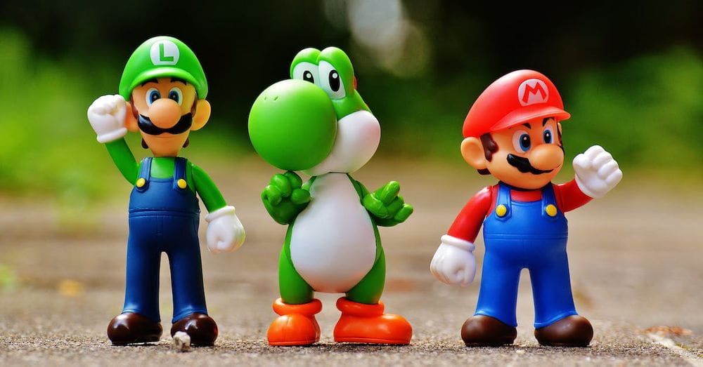 Focus Photo of Super Mario, Luigi, and Yoshi Figurines