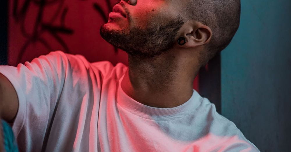 Man Wearing White Crew-neck T-shirt While Looking Up