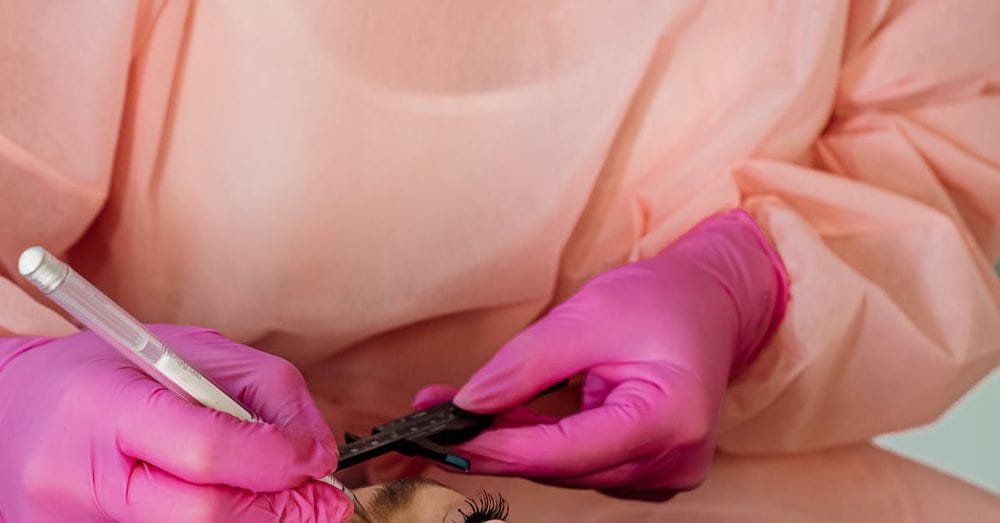 A woman getting her eyebrows done by a doctor