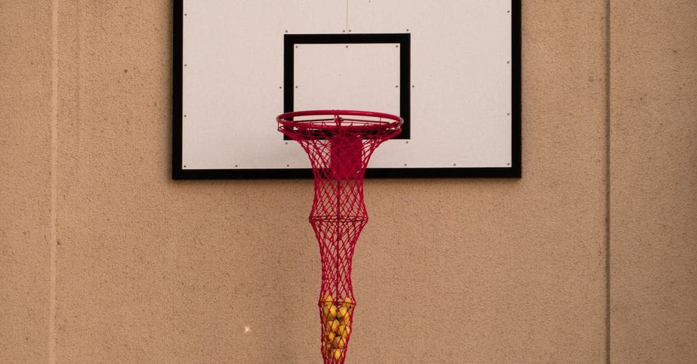 A basketball hoop with a red net hanging from it