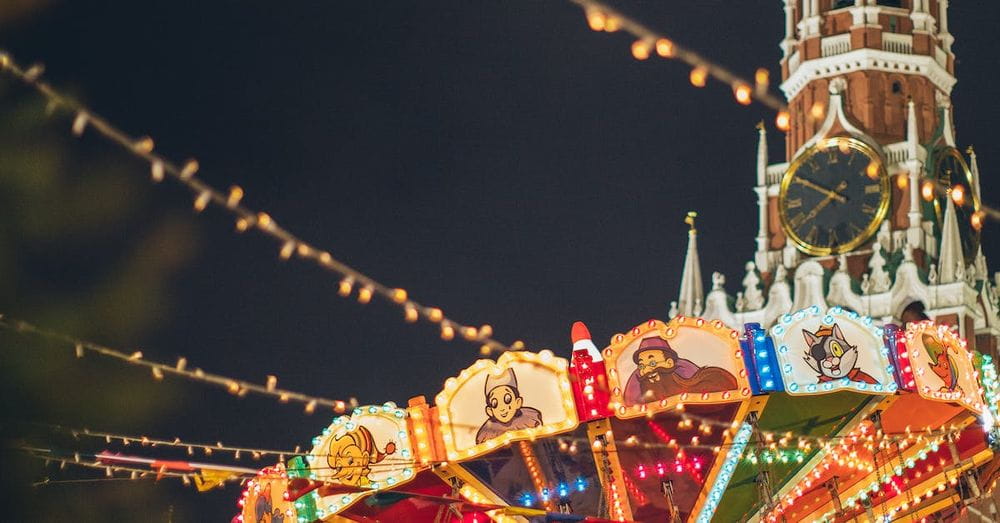 Colorful luminous carousel against Kremlin on Red Square at night