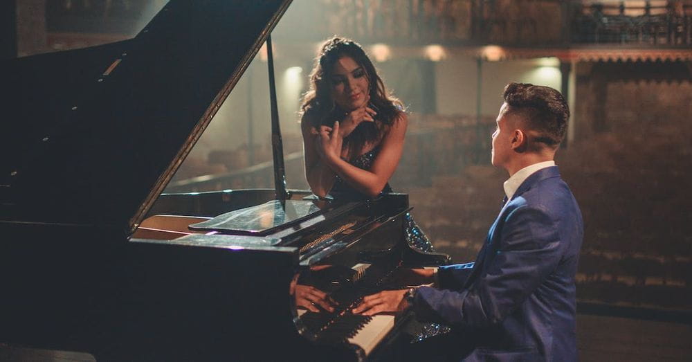 Man playing piano for woman