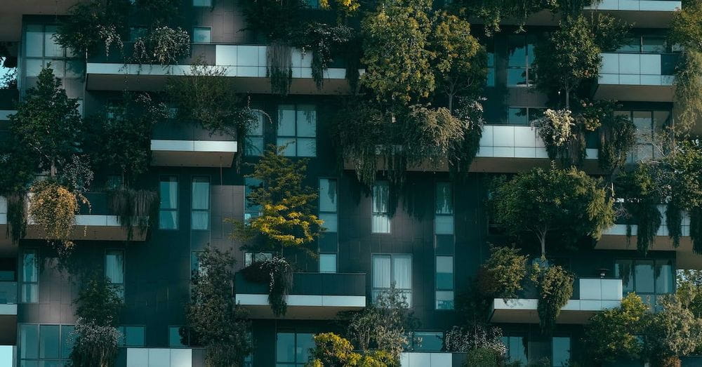 Modern residential building facade decorated with green plants