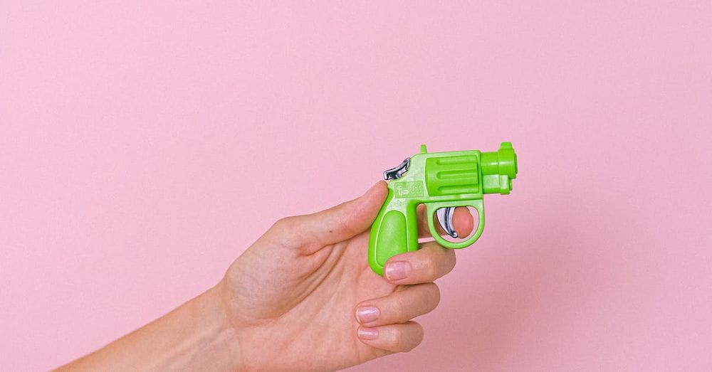 Crop hand with plastic pistol