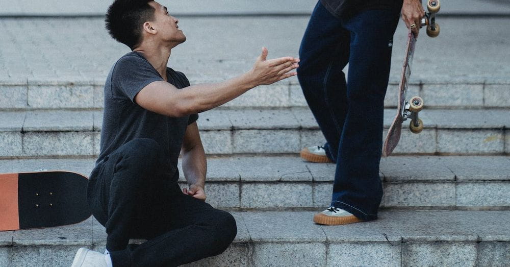 Content Asian male friends clapping each other hands on street