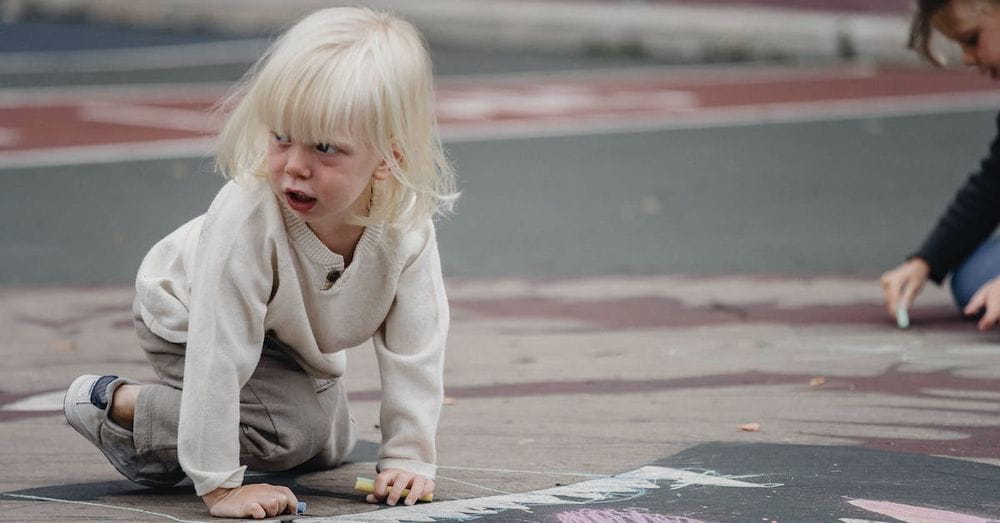 Emotional girl on ground looking away