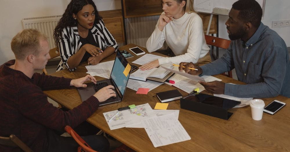 Interracial Group of People Discussing at the Table