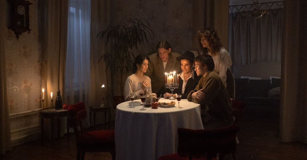 People Gathered Near A Table Celebrating Hanukkah