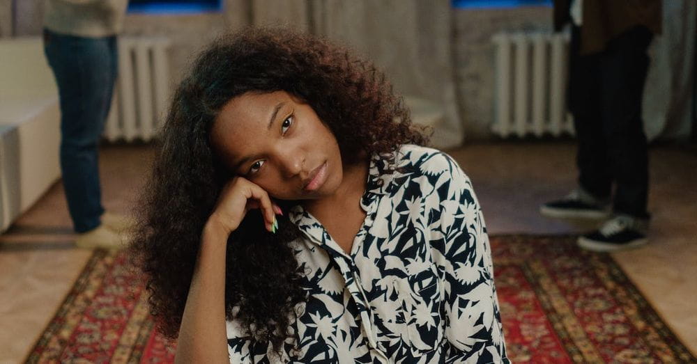 A Sad Young Woman Sitting on a Chair