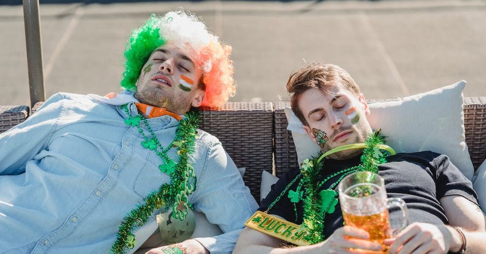 Football fans resting with mug of beer on terrace of bar