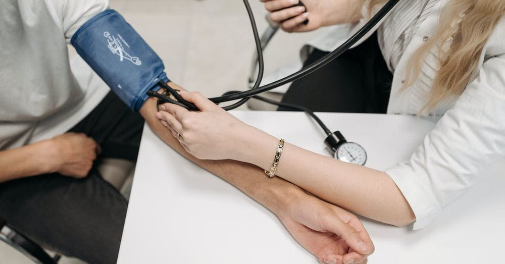 A Healthcare Worker Measuring a Patient's Blood Pressure Using a Sphygmomanometer