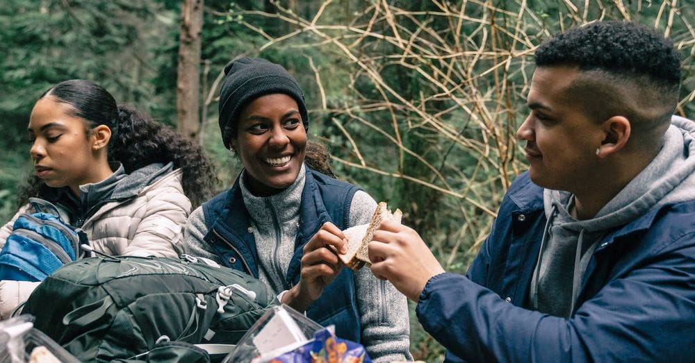 Man and Woman Having Fun while Eating Sandwiches