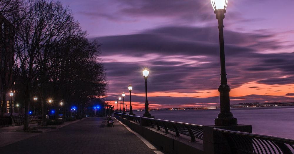 Photography of Turned on Street Lamps Beside Bay during Night Time