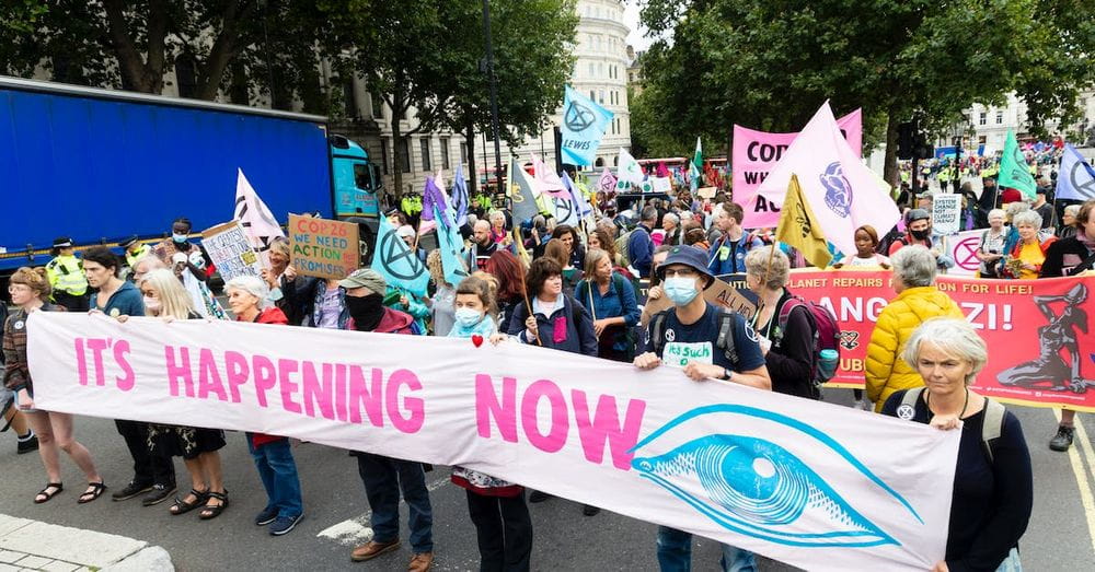 Demonstration of people wearing masks with placards and banners